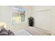 This bedroom features neutral walls, carpeted floors, closet, and a view from large window at 7249 Orchid Island Pl, Bradenton, FL 34202