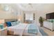 Bright bedroom features built-in desk, tray ceilings and neutral paint with pops of blue decor at 7249 Orchid Island Pl, Bradenton, FL 34202