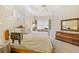 Bedroom features built-in desk, tray ceilings and neutral paint, complete with wood furniture at 7249 Orchid Island Pl, Bradenton, FL 34202