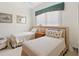 This bedroom features neutral walls, carpeted floors, a patterned bedspread and a view from large window at 7249 Orchid Island Pl, Bradenton, FL 34202