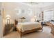 Comfortable bedroom with a wooden bed frame, lamps, and a dedicated workspace at 7249 Orchid Island Pl, Bradenton, FL 34202