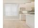 Sunny breakfast nook with white cabinetry, a wine rack, and neutral countertops near a bright window at 7249 Orchid Island Pl, Bradenton, FL 34202