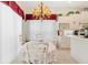 Cozy dining area featuring classic white cabinetry and a decorative chandelier for ambiance at 7249 Orchid Island Pl, Bradenton, FL 34202
