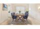 Elegant dining room with a wooden table, blue chairs, and a patterned rug at 7249 Orchid Island Pl, Bradenton, FL 34202