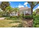 Charming home with lush landscaping, mature palm trees, and a well-maintained lawn, creating a welcoming curb appeal at 7249 Orchid Island Pl, Bradenton, FL 34202