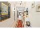 Inviting hallway with tile floors and elegant decor and a view into the living room at 7249 Orchid Island Pl, Bradenton, FL 34202
