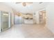 Spacious living room adjacent to kitchen, featuring tiled flooring and ample natural light at 7249 Orchid Island Pl, Bradenton, FL 34202