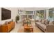 Comfortable living room with built-in shelves and sliding doors to the pool area at 7249 Orchid Island Pl, Bradenton, FL 34202