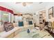Spacious living room with a cozy fireplace and an open view to the kitchen and dining area at 7249 Orchid Island Pl, Bradenton, FL 34202