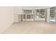 Bright and airy living room with built-in shelves and sliding doors to the pool area at 7249 Orchid Island Pl, Bradenton, FL 34202