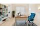 Bright office features built-in bookshelves, tile flooring, large windows and an elegant blue chair at 7249 Orchid Island Pl, Bradenton, FL 34202