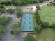 Aerial view of pickleball courts, parking, and golf course near lush landscaping at 7249 Orchid Island Pl, Bradenton, FL 34202