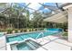 Sparkling pool and spa enclosed by a screen, offering a relaxing retreat with ample space for lounging and entertaining at 7249 Orchid Island Pl, Bradenton, FL 34202