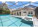 Beautiful screened-in pool and spa, surrounded by a spacious deck and tropical landscaping, perfect for outdoor living at 7249 Orchid Island Pl, Bradenton, FL 34202
