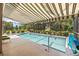 Sparkling pool with screened enclosure, landscaping, and lake view provides relaxation and privacy at 7249 Orchid Island Pl, Bradenton, FL 34202