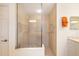 Modern shower with neutral tile, glass enclosure, and convenient grab bar for accessibility at 7249 Orchid Island Pl, Bradenton, FL 34202
