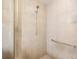 Close-up of the shower featuring neutral tile, glass enclosure, and a helpful grab bar at 7249 Orchid Island Pl, Bradenton, FL 34202