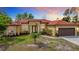 Two-story house with red tile roof and attached garage at 2930 Oceanside St, North Port, FL 34286