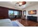 Main bedroom with water views, hardwood floors, and a large TV at 3544 San Remo Ter, Sarasota, FL 34239