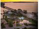 Luxury waterfront home with pool and basketball court, offering stunning sunset views at 3544 San Remo Ter, Sarasota, FL 34239