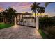 Elegant home exterior with a gated entrance and stone driveway at 3544 San Remo Ter, Sarasota, FL 34239
