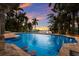 Inviting pool with swim-up bar and gorgeous sunset view at 3544 San Remo Ter, Sarasota, FL 34239