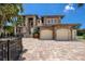 Luxury waterfront home with stone exterior, three-car garage, and paver driveway at 3544 San Remo Ter, Sarasota, FL 34239