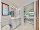 Bathroom with a white vanity, toilet, and view to the primary bedroom at 1415 Piedmont Rd, Venice, FL 34293