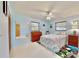 Sunny bedroom featuring wood dresser, tiled floors, and ample sunlight at 1415 Piedmont Rd, Venice, FL 34293