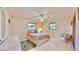 Bright bedroom with two windows, coastal-themed bedding, ceiling fan, and a closet at 1415 Piedmont Rd, Venice, FL 34293