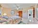 Cozy bedroom with a queen-size bed, ceiling fan, and a closet with bi-fold doors at 1415 Piedmont Rd, Venice, FL 34293