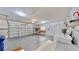 Spacious garage with washer, dryer, work bench, shelving, and overhead storage at 1415 Piedmont Rd, Venice, FL 34293