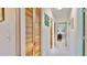 Hallway featuring linen closet and view to primary bedroom at 1415 Piedmont Rd, Venice, FL 34293