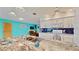 Bright kitchen with white cabinets, granite countertops, and modern appliances at 1415 Piedmont Rd, Venice, FL 34293