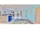 Bright living room showcasing an open floor plan, white tile floors, and access to the outdoor patio at 1415 Piedmont Rd, Venice, FL 34293
