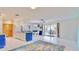 Bright open plan living room showcasing white tile floors and access to the patio at 1415 Piedmont Rd, Venice, FL 34293