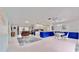 Spacious open floor plan with a living area, kitchen, and dining space with white tile floors at 1415 Piedmont Rd, Venice, FL 34293