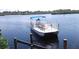 A stunning waterfront view showcasing a large pontoon boat on a sunny day at 1415 Piedmont Rd, Venice, FL 34293