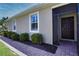 Exterior view of the home's entrance with a nicely landscaped walkway at 13458 Abercrombie Dr, Englewood, FL 34223