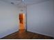 Bedroom with wood flooring and view of kitchen at 13458 Abercrombie Dr, Englewood, FL 34223