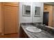 Bathroom with granite countertop, double sinks, and a large mirror at 13458 Abercrombie Dr, Englewood, FL 34223