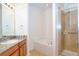 Bathroom with a soaking tub, shower, and granite vanity at 13458 Abercrombie Dr, Englewood, FL 34223