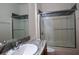 Bathroom with granite countertop, sink, and a glass enclosed shower at 13458 Abercrombie Dr, Englewood, FL 34223