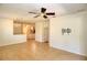 Bright and spacious living room with tile floors and a ceiling fan at 13458 Abercrombie Dr, Englewood, FL 34223
