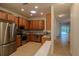 Kitchen with stainless steel appliances and wood cabinets at 13458 Abercrombie Dr, Englewood, FL 34223