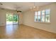 Dining area with tile floors, chandelier, and sliding doors to patio at 13458 Abercrombie Dr, Englewood, FL 34223