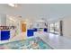Bright kitchen features white cabinets, granite countertops, and blue tile backsplash at 1415 Piedmont Rd, Venice, FL 34293