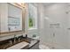 Modern bathroom featuring a glass enclosed shower and dark stone vanity top at 149 Mckinley Dr, Sarasota, FL 34236