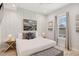 Bright bedroom featuring a large bed, accent wall, and plenty of natural light at 149 Mckinley Dr, Sarasota, FL 34236