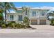 Beautiful two-story home with manicured landscaping, double garages, decorative balconies and covered entry at 149 Mckinley Dr, Sarasota, FL 34236